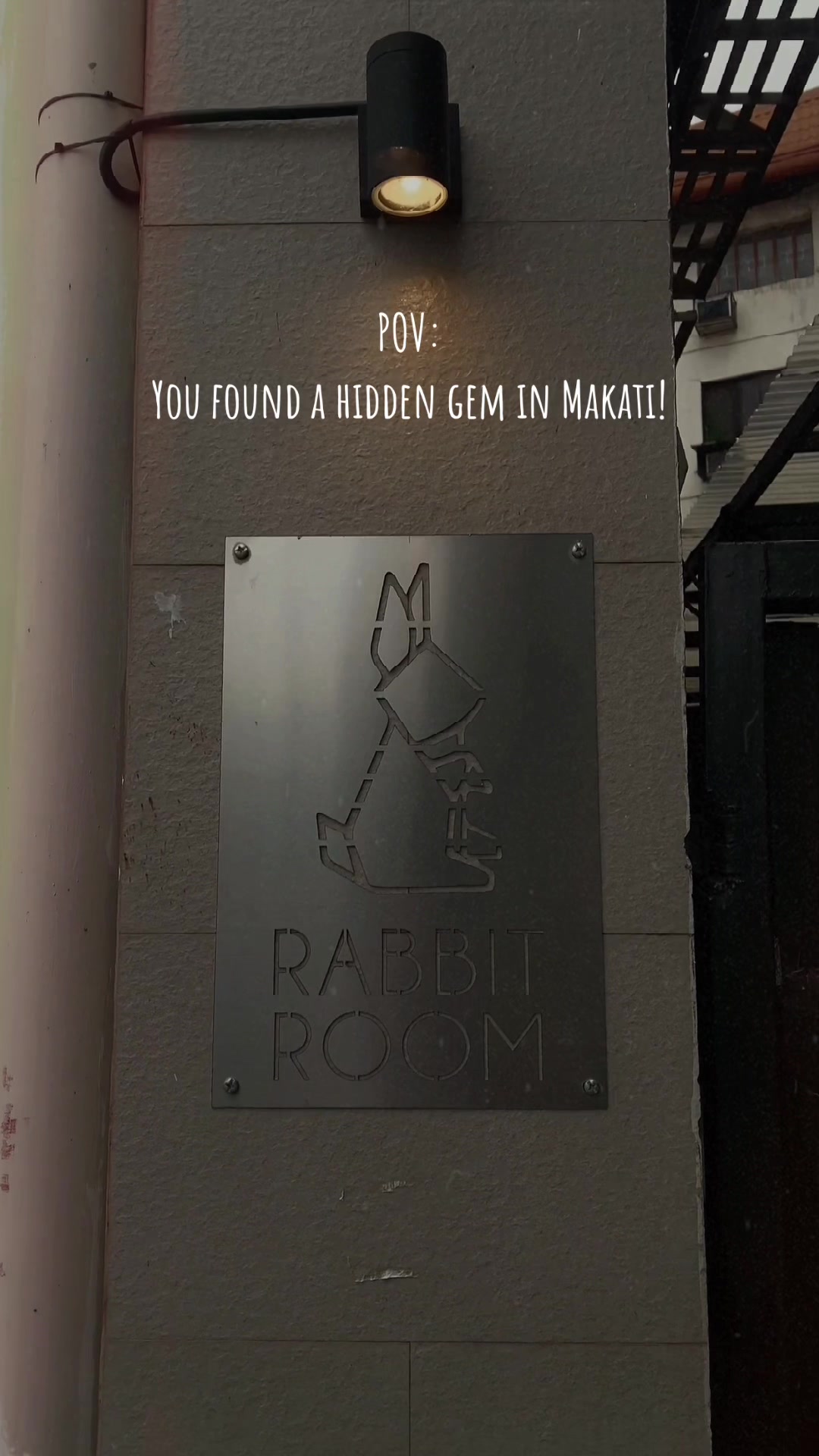 Rabbit Room entrance sign - metal rabbit logo on wall in Makati
