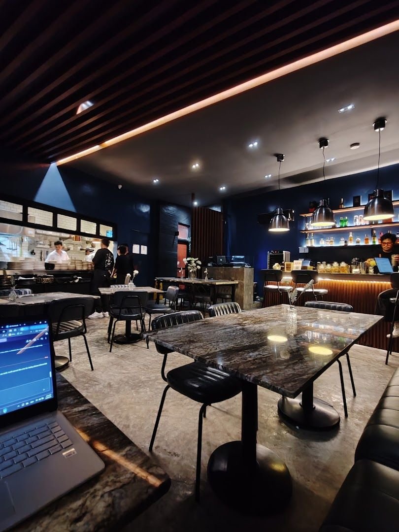 Rabbit Room interior - cobalt blue walls, marble tables, and warm ambient lighting in Makati